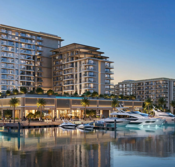 The AUREA by EMAAR residential buildings at Rashid Yachts & Marina, viewed from the water with luxury yachts docked at the pier.