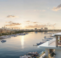 Modern balcony overlooking a busy marina, with people enjoying an outdoor lounge area.