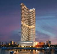 An evening view of the striking BREEZ residential skyscraper, designed with a distinctive curved facade.