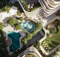 The refreshing swimming pool area with sun loungers and peaceful landscaping .