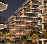 Curved glass residential towers with night lighting and palm trees