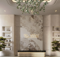 A modern, elegant lobby with marble accents, built-in shelving, decorative lighting, and indoor plants.