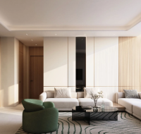 A bright modern living room with large seating, a green chair, and floor-to-ceiling window views.