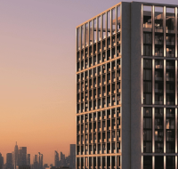 Sunset light reflecting off sleek high-rise with skyline views