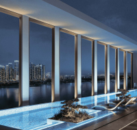Stylish pool deck with scenic views of city skyscrapers at night