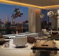 Elegant lounge with pool table, modern seating, and night city views