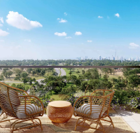 Balcony view overlooking parkland and a road, with high-rise buildings on the horizon.