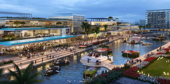 A scenic view of the waterfront promenade and landscaped gardens at DAMAC Riverside, with residents enjoying a leisurely stroll