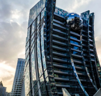 DaVinci Tower's unique architectural design in Business Bay, with a reflective sphere and glass facade.