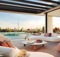 The facade of Émerge Residences in Meydan City, highlighting spacious balconies and the Dubai skyline, including the Burj Khalifa, in the background.