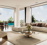 An apartment interior at Émerge Residences, featuring a spacious sofa, modern design, and floor-to-ceiling windows with city views.