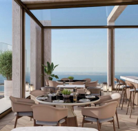 An expansive, unfinished Shell & Core office space with floor-to-ceiling windows and panoramic city views