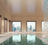 Two-story office lobby and communal workspace with a mezzanine, modern seating, and workstations.