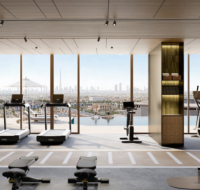 A modern gymnasium with cardio equipment and floor-to-ceiling windows overlooking a swimming pool and the city skyline.