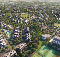 Gated community entrance with modern townhouses