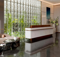 Elegant entrance lobby modern seating and a textured glass wall.