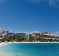 Beachfront residential buildings overlooking the clear blue waters of Palm Jebel Ali, surrounded by palm trees and white sandy shores.