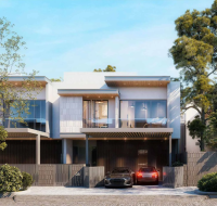 Row of modern villas with integrated carports and lush landscaping along a street.