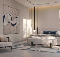 Modern bedroom with a large bed, abstract art, and pendant lighting.