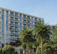 A bright and spacious living area inside a SERA residence, showcasing a clean, modern aesthetic and panoramic views.