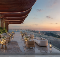 A high-level amenity terrace by Danube Properties, offering dramatic curved architecture and stunning views of the urban landscape.