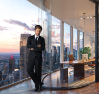 Luxury high-rise office interior featuring a curved balcony, wooden flooring, and a large custom desk.
