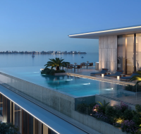 A stunning rooftop infinity pool overlooking a bay, with a lounge area and outdoor seating.