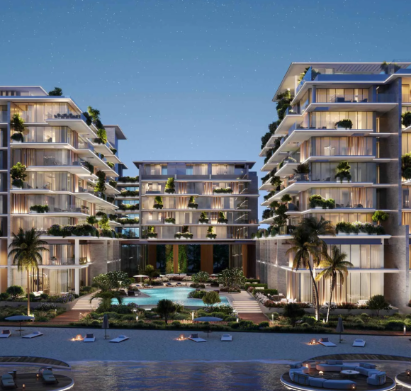 Exterior view of the Silena buildings on Dubai Islands at night, showcasing tiered balconies with lush landscaping.