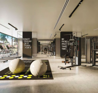 Bright fitness facility with large mirrors, professional equipment, and open training space.
