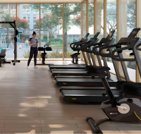 Gym with treadmills facing garden and floor-to-ceiling windows