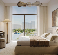 The elegant bedroom interior of a Terra Gardens home, with contemporary furniture and a view of the resort amenities.