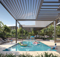 Residential children's pool and lounge area featuring a modern pergola and families enjoying the water.