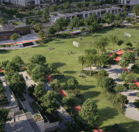 Aerial view of a large residential central park featuring walking paths, sports fields, and abundant green trees.