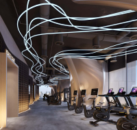 Modern fitness center with treadmills, exercise bikes, unique ceiling lights, and city views.