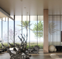 Spacious gym area with floor-to-ceiling mirrors and high-end workout equipment