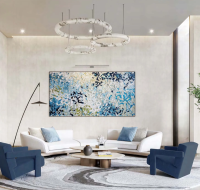 Modern lounge area with sofas, chairs, and abstract wall art