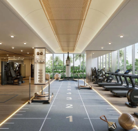 Modern gym with cardio machines, training equipment, and large windows